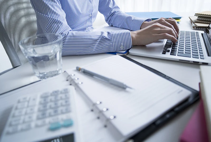 Entering numbers on the computer to run the temporary recruitment payroll
