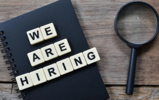 'We are hiring' letters and magnifying glass